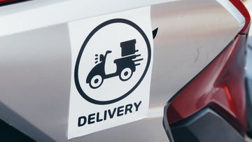 Die-cut delivery sticker on vehicle